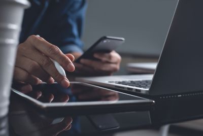 man working on desktop, tablet, phone, Modern Device Management | DXC Technology